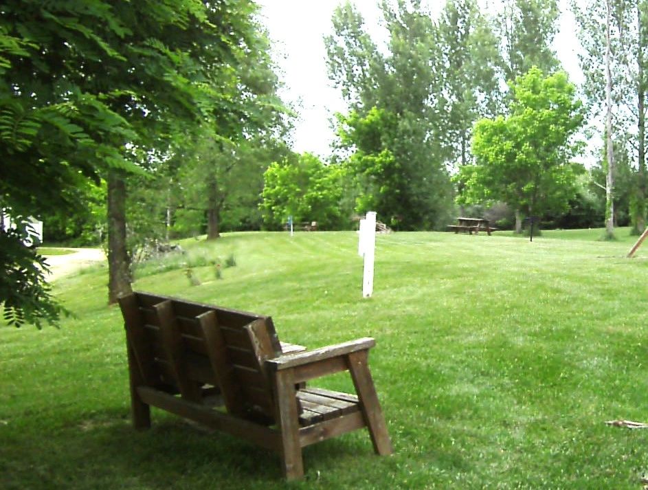 RV campground with green trees and scenic views at Lamplight RV Park